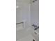 This bathroom boasts a pristine white tub with shower, offering a clean and modern look at 4805 Kellys Mill Nw Dr, Lilburn, GA 30047
