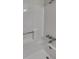 This bathroom boasts a pristine white tub with shower, offering a clean and modern look at 4805 Kellys Mill Nw Dr, Lilburn, GA 30047