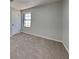 This carpeted bedroom provides a peaceful retreat with a window view and neutral wall color at 4805 Kellys Mill Nw Dr, Lilburn, GA 30047