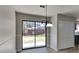 Dining area with sliding glass doors to the backyard, closet space, and modern lighting at 4805 Kellys Mill Nw Dr, Lilburn, GA 30047