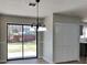 Dining area with sliding glass doors to backyard, closet, and modern lighting fixture at 4805 Kellys Mill Nw Dr, Lilburn, GA 30047