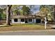 Charming single-story home with a well-maintained lawn, black shutters and a one car garage in a wooded setting at 4805 Kellys Mill Nw Dr, Lilburn, GA 30047