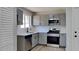 Modern kitchen featuring gray cabinetry, subway tile backsplash, stainless steel appliances, and white countertops at 4805 Kellys Mill Nw Dr, Lilburn, GA 30047
