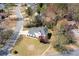 Aerial view of a charming two-story home with a well-manicured lawn and mature trees at 966 Laurel Springs Sw Ln, Marietta, GA 30064