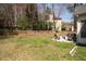 Well-maintained backyard with a patio featuring outdoor chairs, firepit, and a wooden fence at 966 Laurel Springs Sw Ln, Marietta, GA 30064