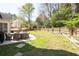 Spacious backyard with a patio featuring outdoor dining set, all surrounded by a wooden fence at 966 Laurel Springs Sw Ln, Marietta, GA 30064