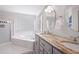 Bright bathroom features dual vanity, soaking tub, and glass enclosed shower at 966 Laurel Springs Sw Ln, Marietta, GA 30064