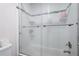 Shower featuring a tile surround and glass enclosure with shelving at 966 Laurel Springs Sw Ln, Marietta, GA 30064