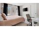 Cozy bedroom with neutral colors, complemented by a well lit workspace at 966 Laurel Springs Sw Ln, Marietta, GA 30064