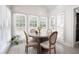 Bright breakfast nook with round table and views from the large windows at 966 Laurel Springs Sw Ln, Marietta, GA 30064