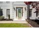 Charming front door with glass storm door, decorative wreath and plants in well-maintained flower beds at 966 Laurel Springs Sw Ln, Marietta, GA 30064