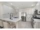 Well-lit kitchen featuring white cabinets, quartz counters, island and stainless steel appliances at 966 Laurel Springs Sw Ln, Marietta, GA 30064