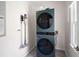 Modern laundry area with stacked washer and dryer unit and tiled floors at 966 Laurel Springs Sw Ln, Marietta, GA 30064