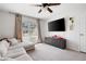 Bright living room featuring a large sofa, TV and natural lighting at 966 Laurel Springs Sw Ln, Marietta, GA 30064
