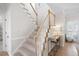 Bright staircase with carpeted steps and white wooden railings, adjacent to a hallway console table at 966 Laurel Springs Sw Ln, Marietta, GA 30064