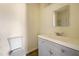 Bathroom with a modern vanity, gray cabinets, mirror, toilet and white walls at 2391 Cove Rd, Lithonia, GA 30058