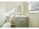 Bathroom with a modern vanity, toilet, window with blinds, and neutral paint at 2391 Cove Rd, Lithonia, GA 30058