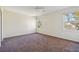 Large bedroom with carpeted floors, natural light from two windows, and closet at 2391 Cove Rd, Lithonia, GA 30058