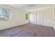 Bedroom with carpeted floor, windows, and closets that offer ample storage space at 2391 Cove Rd, Lithonia, GA 30058