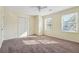 Bedroom featuring carpeted floors, a ceiling fan, natural light from two windows, and closet at 2391 Cove Rd, Lithonia, GA 30058