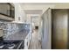 Modern kitchen featuring stainless steel appliances, granite countertops, tile backsplash, and white cabinetry at 2391 Cove Rd, Lithonia, GA 30058
