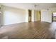 Spacious living room showcasing new floors, a ceiling fan, and an open view into the kitchen at 2391 Cove Rd, Lithonia, GA 30058