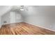 Finished attic bedroom features wood floors, neutral paint, lots of natural light and ceiling fan at 2650 Hamilton Chase Run, Buford, GA 30519