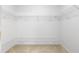 Walk-in closet with installed white wire shelving, and neutral carpeting at 2650 Hamilton Chase Run, Buford, GA 30519