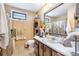 Traditional bathroom with a large mirror, wooden cabinets, and tiled floors at 2720 Cold Springs Sw Trl, Marietta, GA 30064