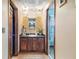 Hall bathroom with dark wooden cabinets, vanity and views into other rooms at 2720 Cold Springs Sw Trl, Marietta, GA 30064
