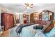 Spacious bedroom with carpet, wooden furniture, a ceiling fan and comfortable bed at 2720 Cold Springs Sw Trl, Marietta, GA 30064