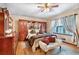 Comfortable bedroom featuring a ceiling fan, built-in wardrobe, and a cozy seating area at 2720 Cold Springs Sw Trl, Marietta, GA 30064