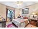 Cozy bedroom features a ceiling fan, hardwood floors and comfortable decor at 2720 Cold Springs Sw Trl, Marietta, GA 30064