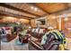 Living room with wood beamed ceiling, stone fireplace, leather furniture, and stone fireplace at 2720 Cold Springs Sw Trl, Marietta, GA 30064