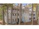 Gray two-story condo with white trim, multiple balconies and wooden stairs at 409 Natchez Trce, Sandy Springs, GA 30350