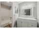 Bathroom featuring a tub, shower, toilet, and vanity with double sinks and ample lighting at 409 Natchez Trce, Sandy Springs, GA 30350