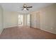 Spacious bedroom features neutral walls, carpeted floors, ceiling fan, and two entryways at 409 Natchez Trce, Sandy Springs, GA 30350