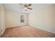 Spacious bedroom with neutral walls, carpeted floors, ceiling fan, and natural light from a window at 409 Natchez Trce, Sandy Springs, GA 30350