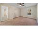 Carpeted bedroom with a ceiling fan, a window, and neutral paint at 409 Natchez Trce, Sandy Springs, GA 30350