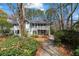 Inviting home exterior featuring a landscaped front yard, a walkway, and charming architectural details at 409 Natchez Trce, Sandy Springs, GA 30350