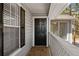 The front porch has black window shutters, a black front door and a wood porch at 409 Natchez Trce, Sandy Springs, GA 30350