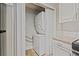 A stacked washer and dryer closet is conveniently located in the kitchen area at 409 Natchez Trce, Sandy Springs, GA 30350