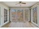 View of the bright sun room with walls of windows and doors at 409 Natchez Trce, Sandy Springs, GA 30350
