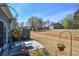 A lovely backyard with a concrete patio, lush greenery, and hanging plants for relaxing outdoor enjoyment at 904 Magnolia Leaf Dr, Woodstock, GA 30188