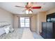 Cozy bedroom featuring a ceiling fan, bright window, and stylish decor at 904 Magnolia Leaf Dr, Woodstock, GA 30188