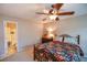 Cozy bedroom with a ceiling fan, comfortable bedding, and an ensuite bathroom providing a relaxing retreat at 904 Magnolia Leaf Dr, Woodstock, GA 30188