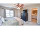 Bedroom featuring carpeted floors, a ceiling fan, and an attached bathroom at 904 Magnolia Leaf Dr, Woodstock, GA 30188
