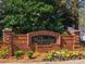 The Magnolias at Ridgewalk brick community sign is surrounded by colorful flowers and lush greenery at 904 Magnolia Leaf Dr, Woodstock, GA 30188