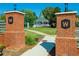 Welcoming park entrance featuring brick pillars, manicured landscaping, and a glimpse of a charming gazebo in the distance at 904 Magnolia Leaf Dr, Woodstock, GA 30188