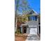 A townhome with brick and siding and an attached garage stands under a blue sky at 904 Magnolia Leaf Dr, Woodstock, GA 30188